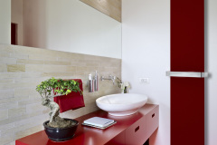 modern red furniture for washbasin and wood floor in a bathroom